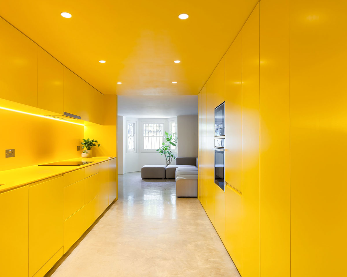 Russian For Fish Brighten Basement of London Home With Vibrant Yellow Kitchen