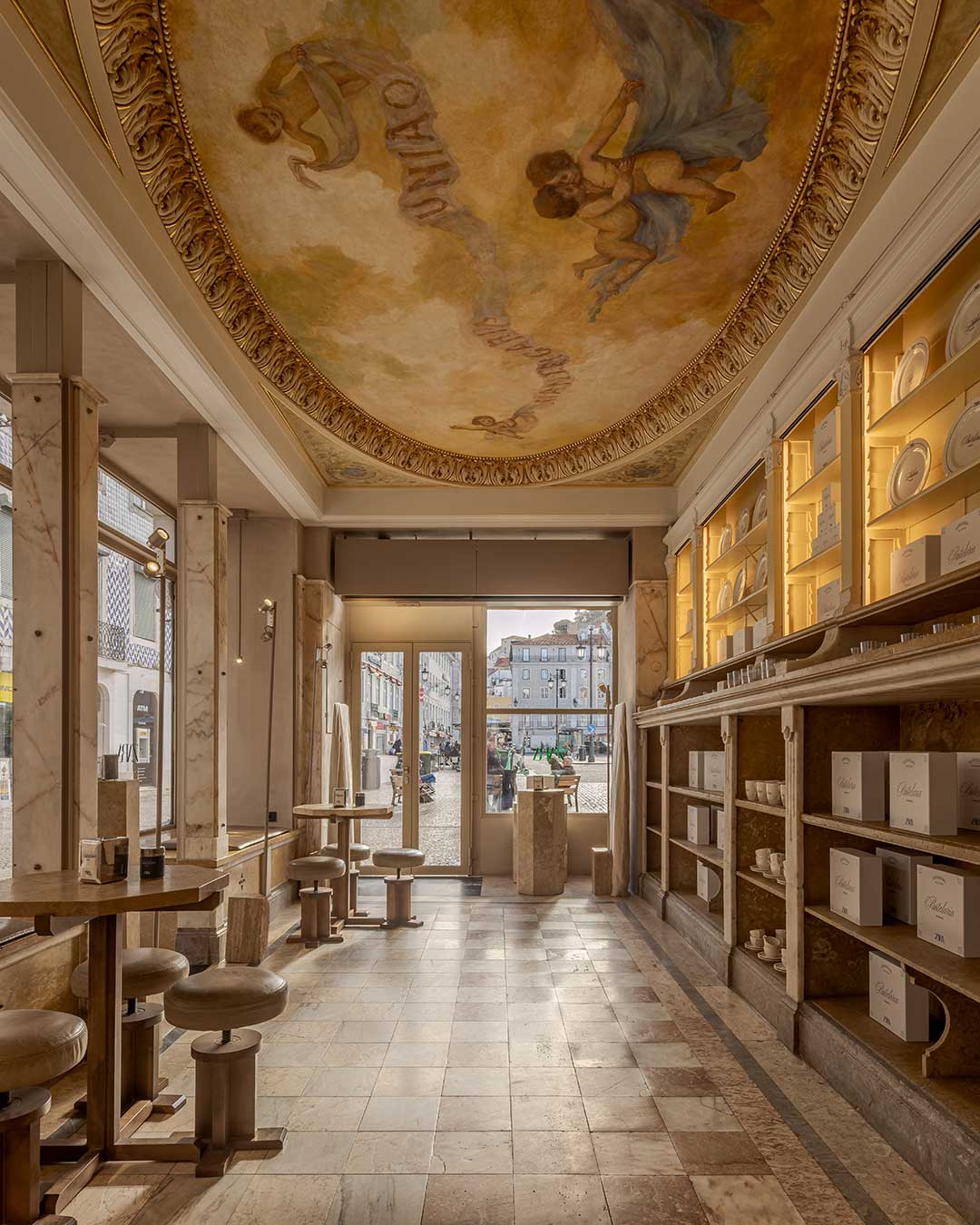 The new Zara Rossio flagship in Lisbon is a sensory dialogue between history and modernity. Contacto Atlântico has meticulously restored this 200-year-old landmark, treating the building as a fluid extension of the streetscape. Inside, the past is tactile: original geometric floor tiles and decorative plasterwork meet contemporary retail displays, all illuminated by natural light permeating through historic light wells.

Visitors can pause for a pastel de nata at Castro by Zara, sitting beneath a restored ceiling painting of two putti, or browse the beauty section with framed views of the Castelo de São Jorge. This is a retail experience that rewards the observant, where "invisible engineering" allows the craftsmanship of the past to lead the narrative.

via #urdesignmag 
architects @contactoatlantico
images @fernandogguerra 

#LisbonArchitecture #ZaraRossio #HistoricRestoration #InteriorDesign #BaixaPombalina #PortugueseDesign #RetailArchitecture #HeritageRestoration #UrbanFabric #ContactoAtlantico #LisbonLife