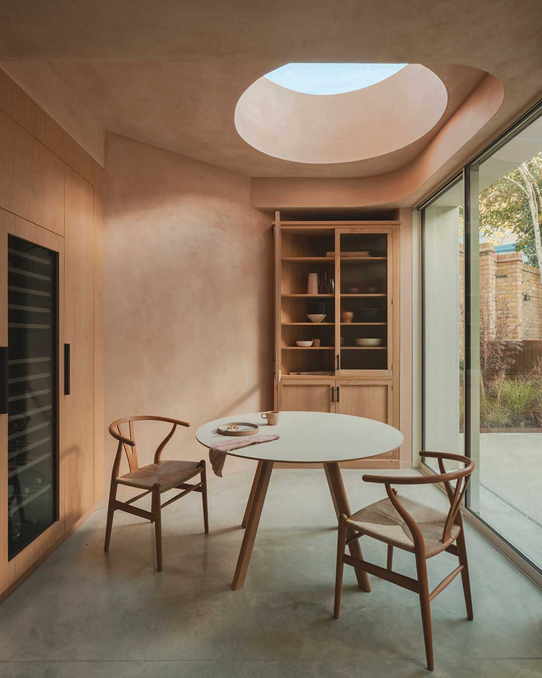 A rhythmic response to urban geometry. Studio 163 Architects tackles a challenging triangular plot between Highgate and Hampstead Heath, utilizing the tactile, creamy tonality of Dorset-sourced Portland Stone to anchor a new light-filled extension. The exterior’s monolithic presence offers a calm backdrop for the play of shadows, providing a sense of permanence within London’s dense fabric.

Inside, the atmosphere shifts toward soft geometry and hushed acoustics. Natural clay plaster walls and zenithal light from a singular circular roof light create a tempered, breathable environment. Every corner of the irregular floor plan is maximized through bespoke walnut and sage green joinery, blurring the lines between the historic Victorian bones and a minimalist, sustainable future.

via #urdesignmag 
architects @studio.163 
images @_peter_molloy_ 

#Studio163 #LondonArchitecture #PortlandStone #InteriorInspo #SustainableDesign #ModernExtension #ArchitecturalPhotography #ClayPlaster #Retrofit #DesignDetails #LondonHomes #MinimalistArchitecture