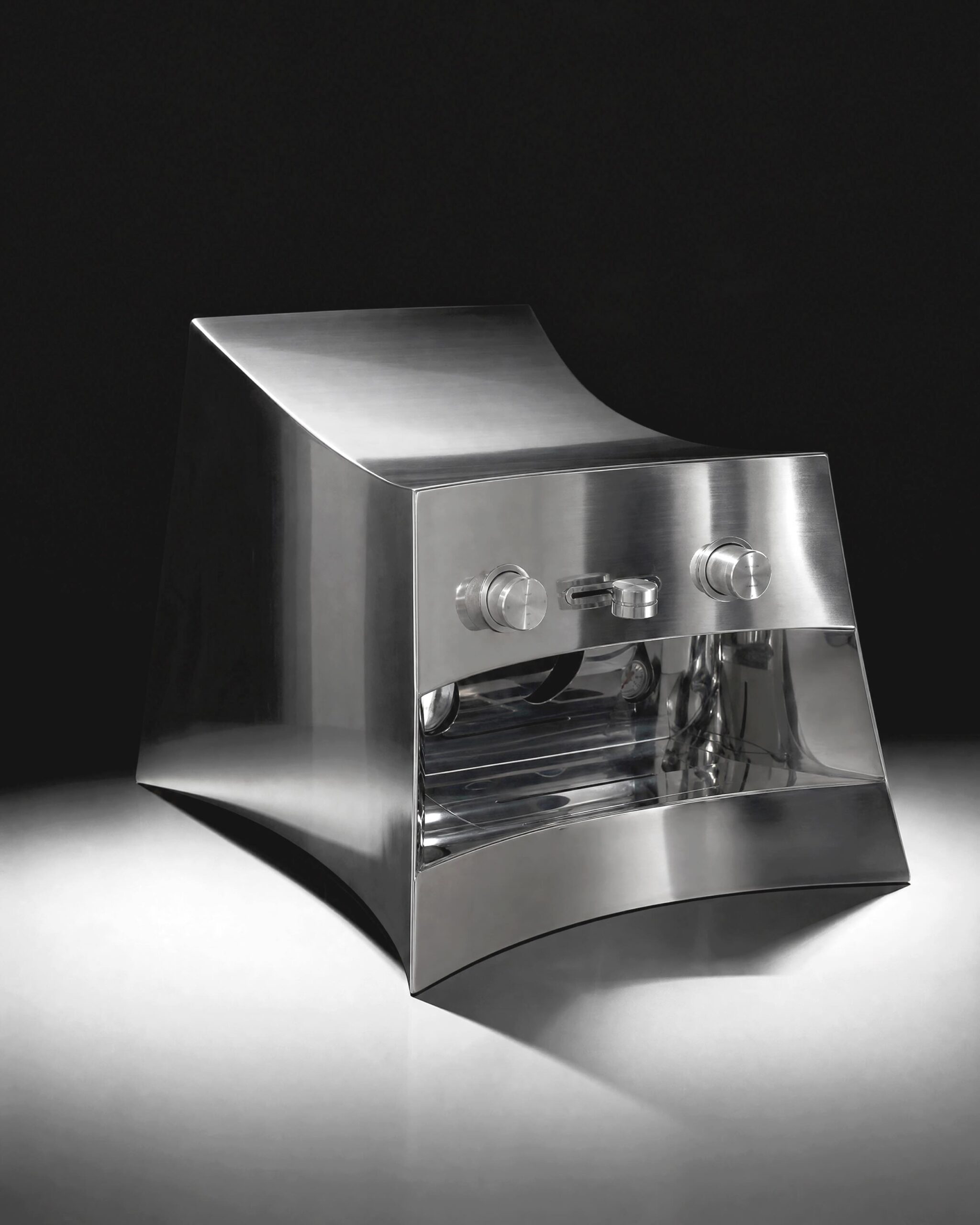 CALIPER rebuilt a @lamarzocco Marzocco Linea Mini's entire housing in curved, polished stainless steel — no vertical line, no flat top, no surface left where a cup or a spare bag of beans could sit. Built for Heliot Emil's Paris SS27 showroom "Troxler" and unveiled by Joe & The Juice during Paris Men's Fashion Week.  Two machined knobs carry both brand names etched directly into the metal, alongside the numbers 07, 13, 25, 34 — a reference to Heliot Emil's four design pillars.  design: @calip.er 
development: @danielrome.p 
Commissioned by @heliot_emil, @joeandthejuice  urdesignmag.com — link in bio  #CALIPER #LaMarzocco #HeliotEmil #IndustrialDesign #ParisFashionWeek