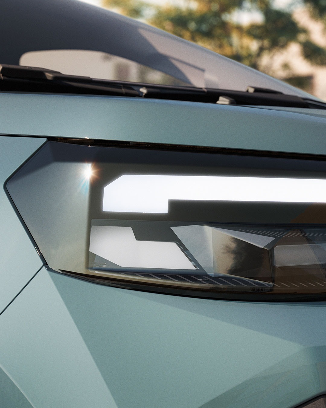 Only the upper bar of each lamp is lit. The section below it is a plain surface angled at 45 degrees, catching the light from above to complete the shape optically — half the light signature on the New Dacia Spring is a reflection, not a lamp. Premium brands solve the same problem by adding a second light source. Here the angled surface does the work instead, adding depth and a floating effect with a limited number of illuminated parts. On a car priced under €20,000, the cheaper answer and the better-looking one turn out to be the same one. Dacia Design — New Dacia Spring Images: Dacia Design / RECOM Paris urdesignmag.com — link in bio #dacia #daciaspring #cardesign #lightsignature #frugalengineering