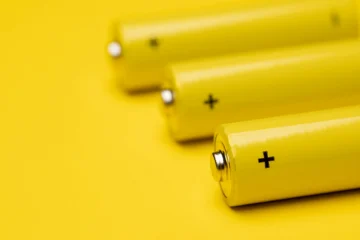 Yellow alkaline batteries colorful background