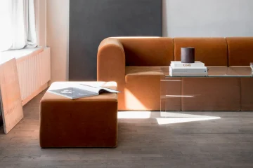 Modern living room with geometric sofa and glass coffee table