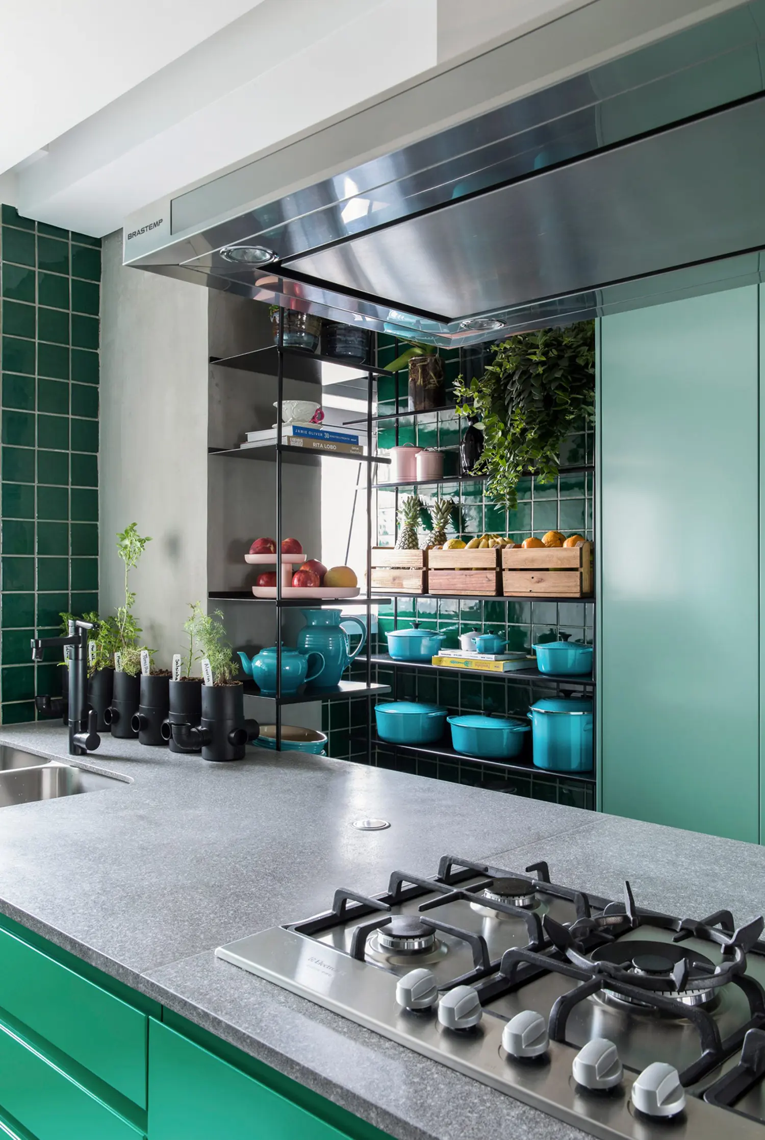 Kitchen with mint green cabinets and emerald tiles
