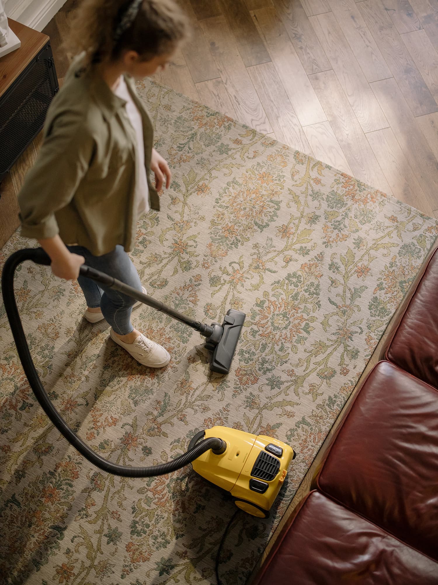 Person Holding Yellow and Black Vacuum Cleaner