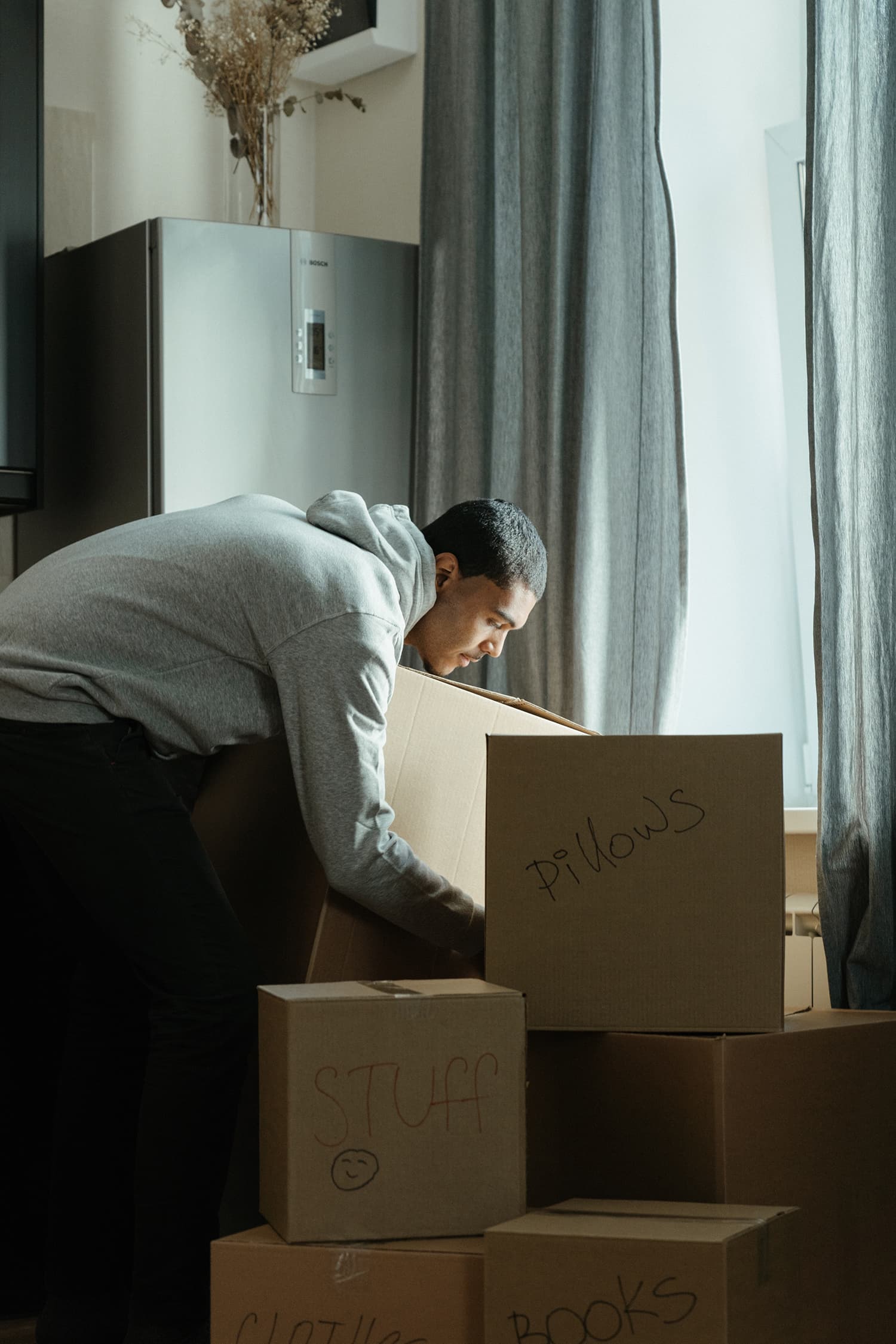 Man arranges moving boxes