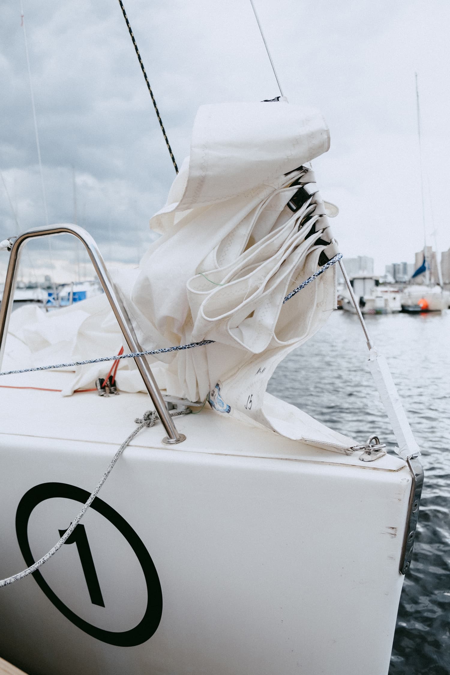 Bow of a boat with white sail