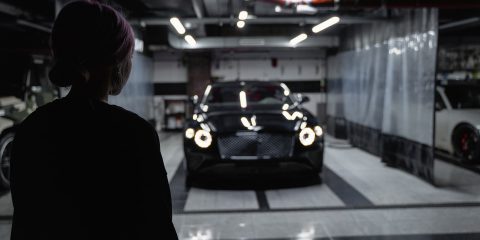 A Woman Looking at the Black Car