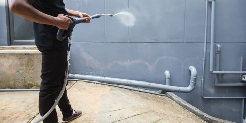 A man cleaning with high pressure water jet