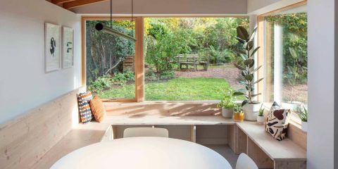 Kitchen with large window overlooking backyard