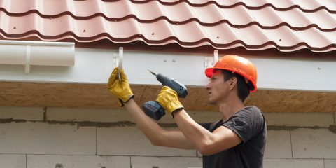 Worker installs gutter system
