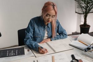Young architecture student sitting at desk