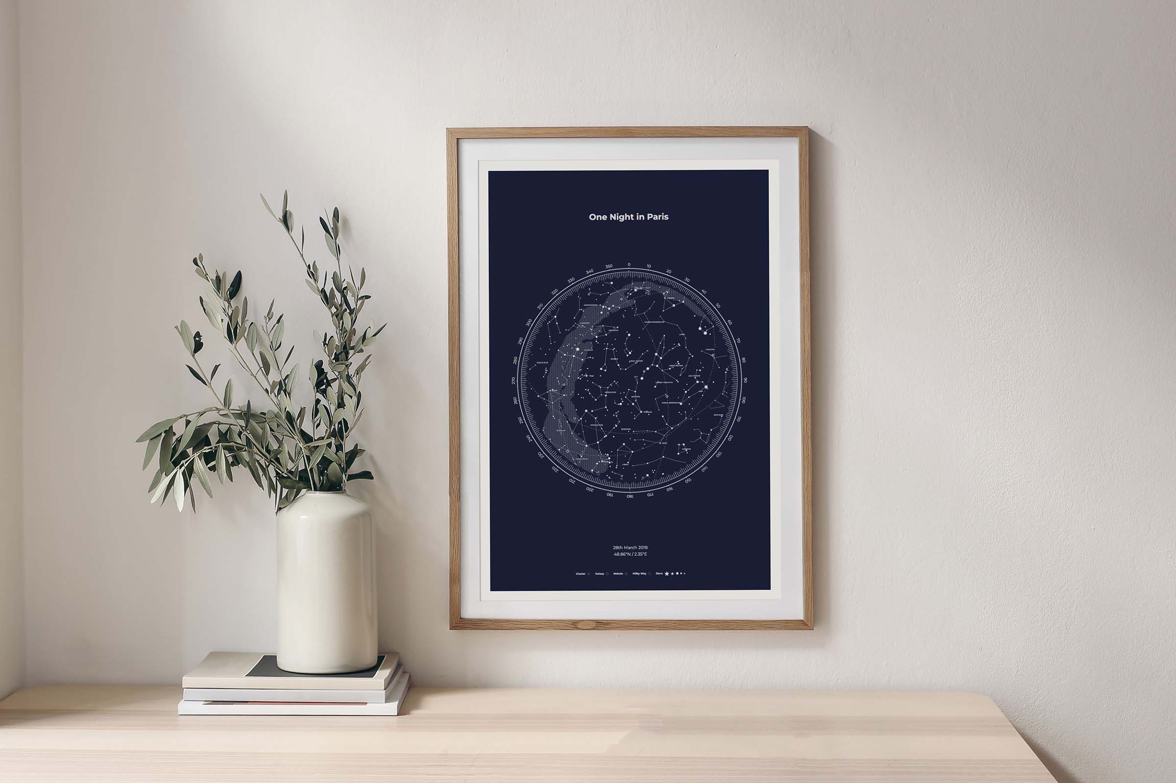 Frame with star map printed on blue paper hanging on the wall