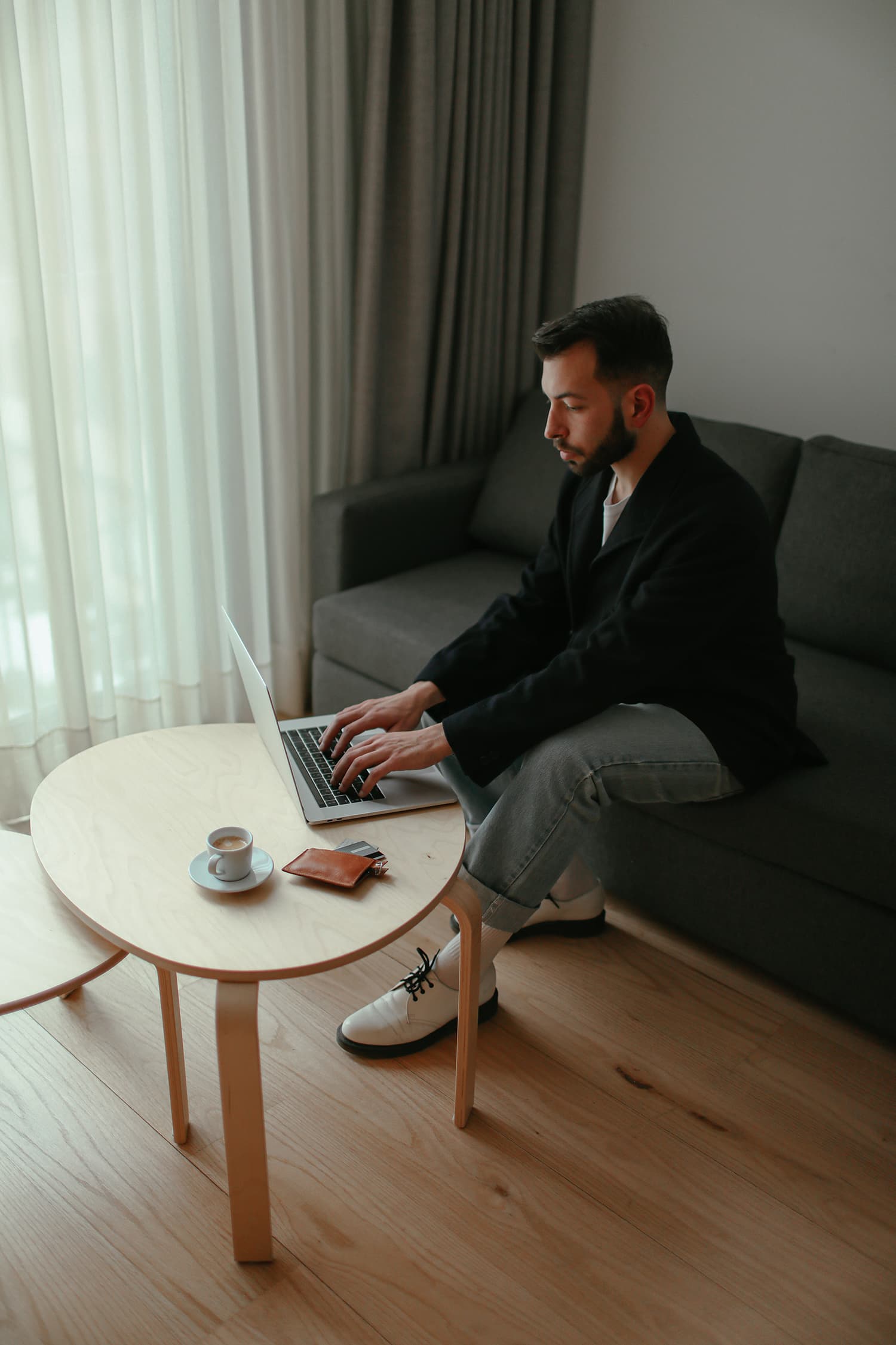 Man in Using a Laptop while Sitting on a Couch