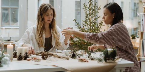 Two women make Christmas decorations