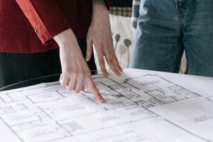 People standing around a table with a floor plan