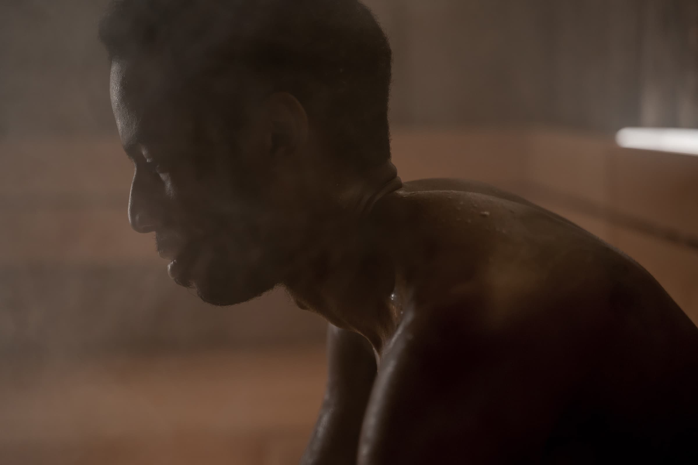 Close-up on sweaty afro man in a sauna