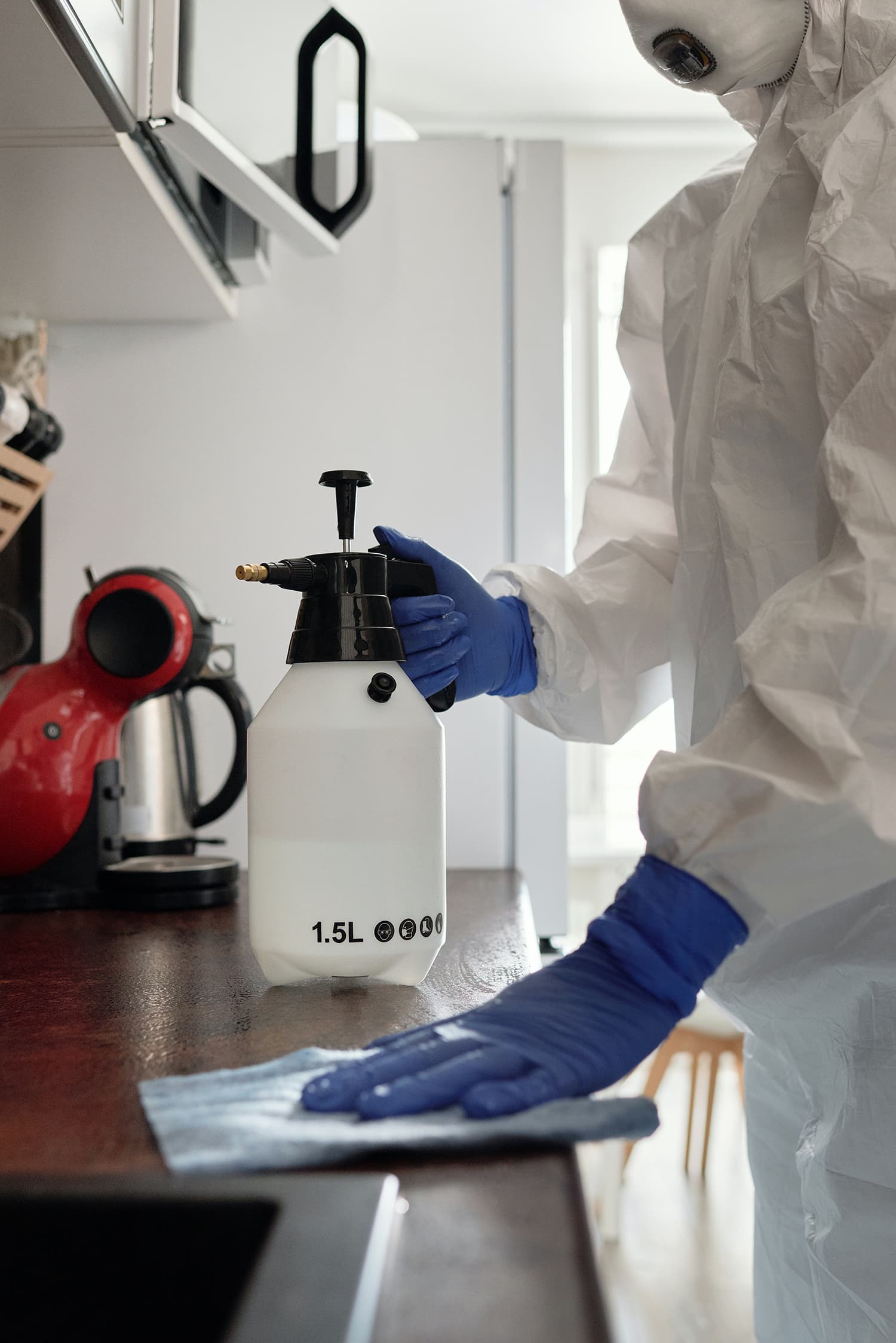 Close-up on woman in protective suit and plastic gloves