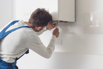 Professional plumber checking a boiler