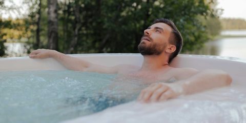 Man relaxes in a jacuzzi tub