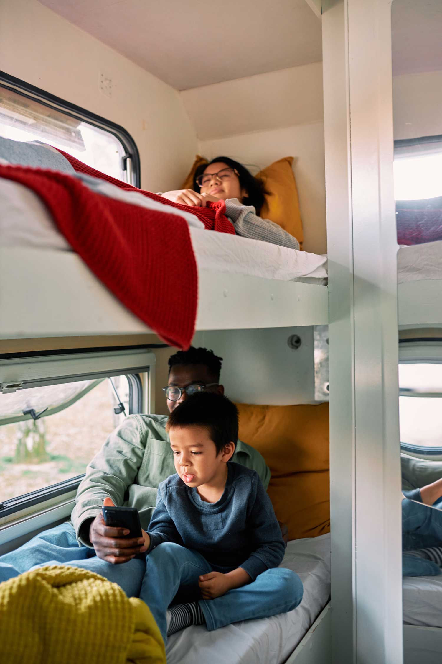 A multicultural nomadic family relaxes in a van
