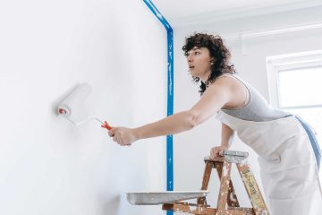 Woman paints walls in her apartment