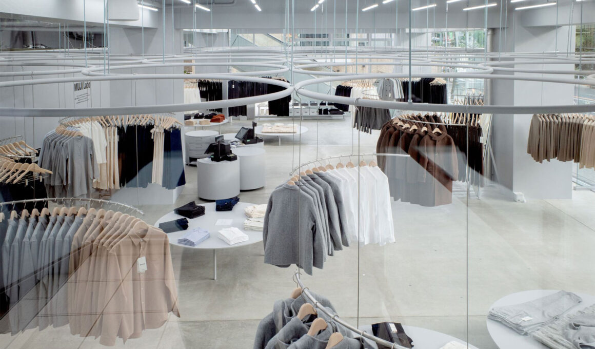 MUJI Labo Tokyo by SANAA — overhead view of ceiling-mounted ring display system with suspended garments, polished concrete floor