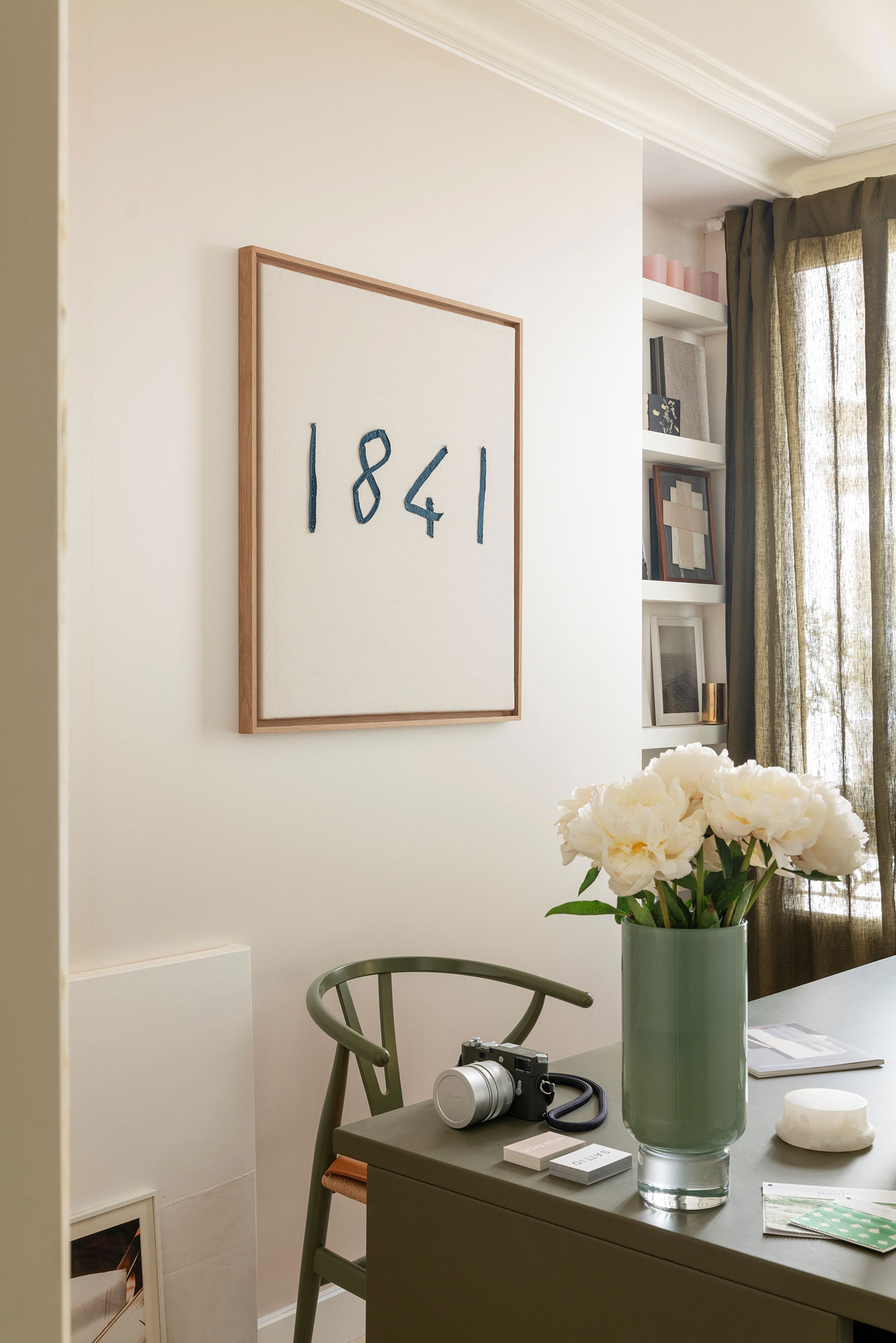 Images showcasing the stunning architectural renovation of a Haussmann apartment in Auteuil, Paris, by After Bach studio. The design blends classic Parisian charm with modern sensibilities, highlighting the use of natural materials, a sophisticated color palette, and curated artwork.