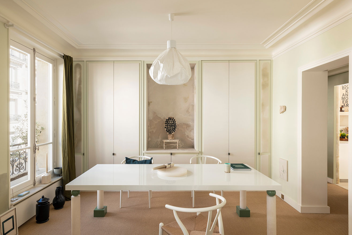 Images showcasing the stunning architectural renovation of a Haussmann apartment in Auteuil, Paris, by After Bach studio. The design blends classic Parisian charm with modern sensibilities, highlighting the use of natural materials, a sophisticated color palette, and curated artwork.