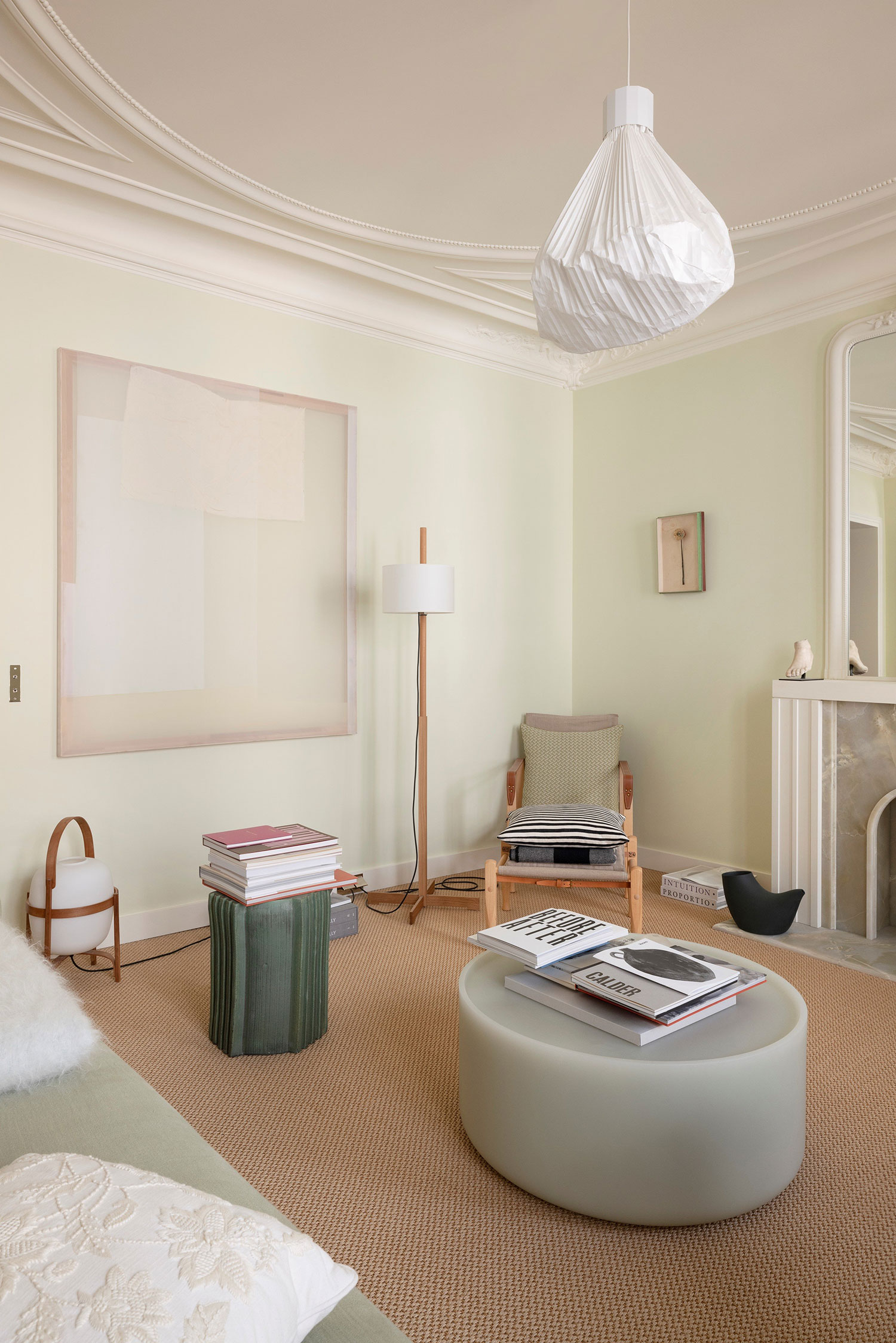 Images showcasing the stunning architectural renovation of a Haussmann apartment in Auteuil, Paris, by After Bach studio. The design blends classic Parisian charm with modern sensibilities, highlighting the use of natural materials, a sophisticated color palette, and curated artwork.