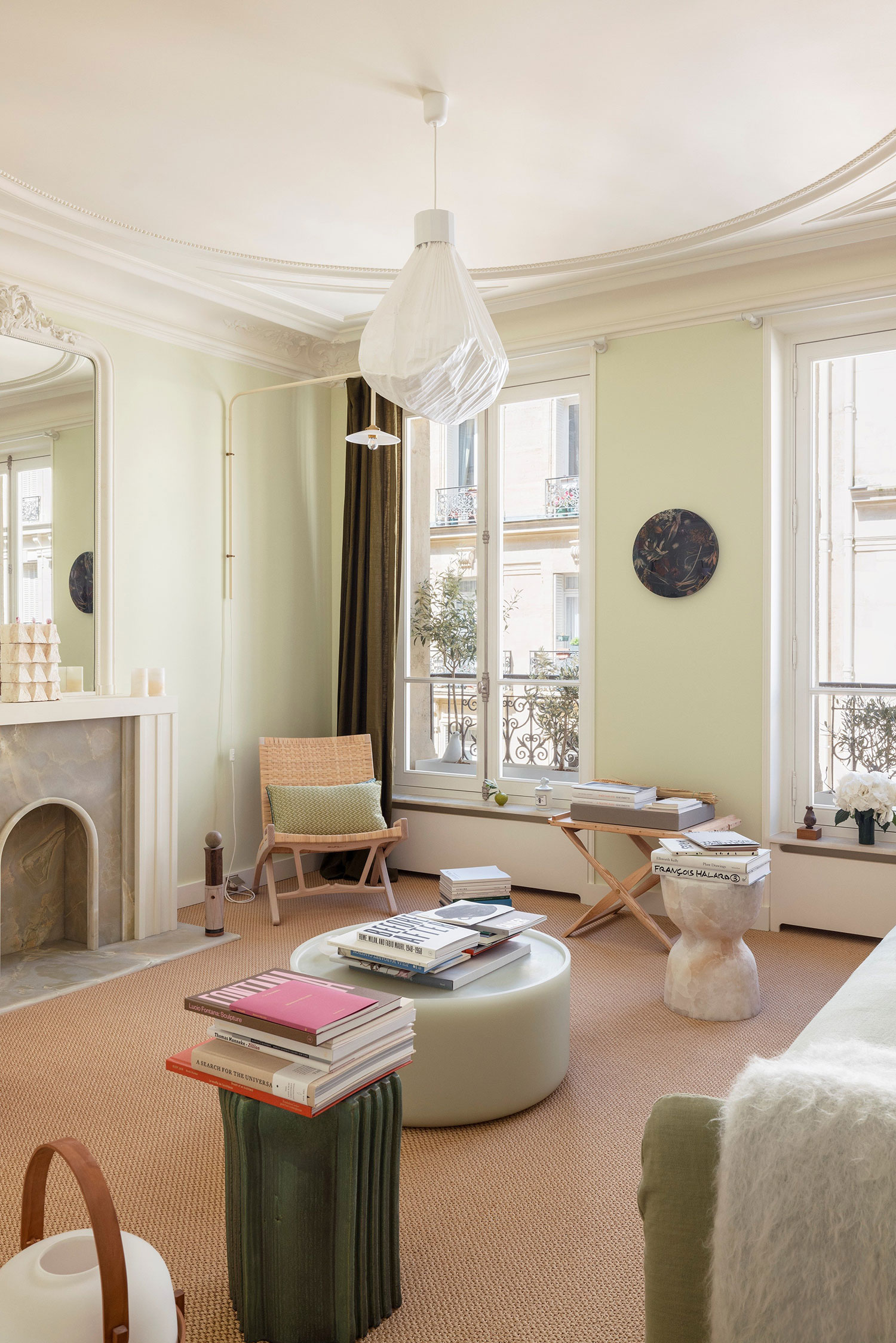 Images showcasing the stunning architectural renovation of a Haussmann apartment in Auteuil, Paris, by After Bach studio. The design blends classic Parisian charm with modern sensibilities, highlighting the use of natural materials, a sophisticated color palette, and curated artwork.