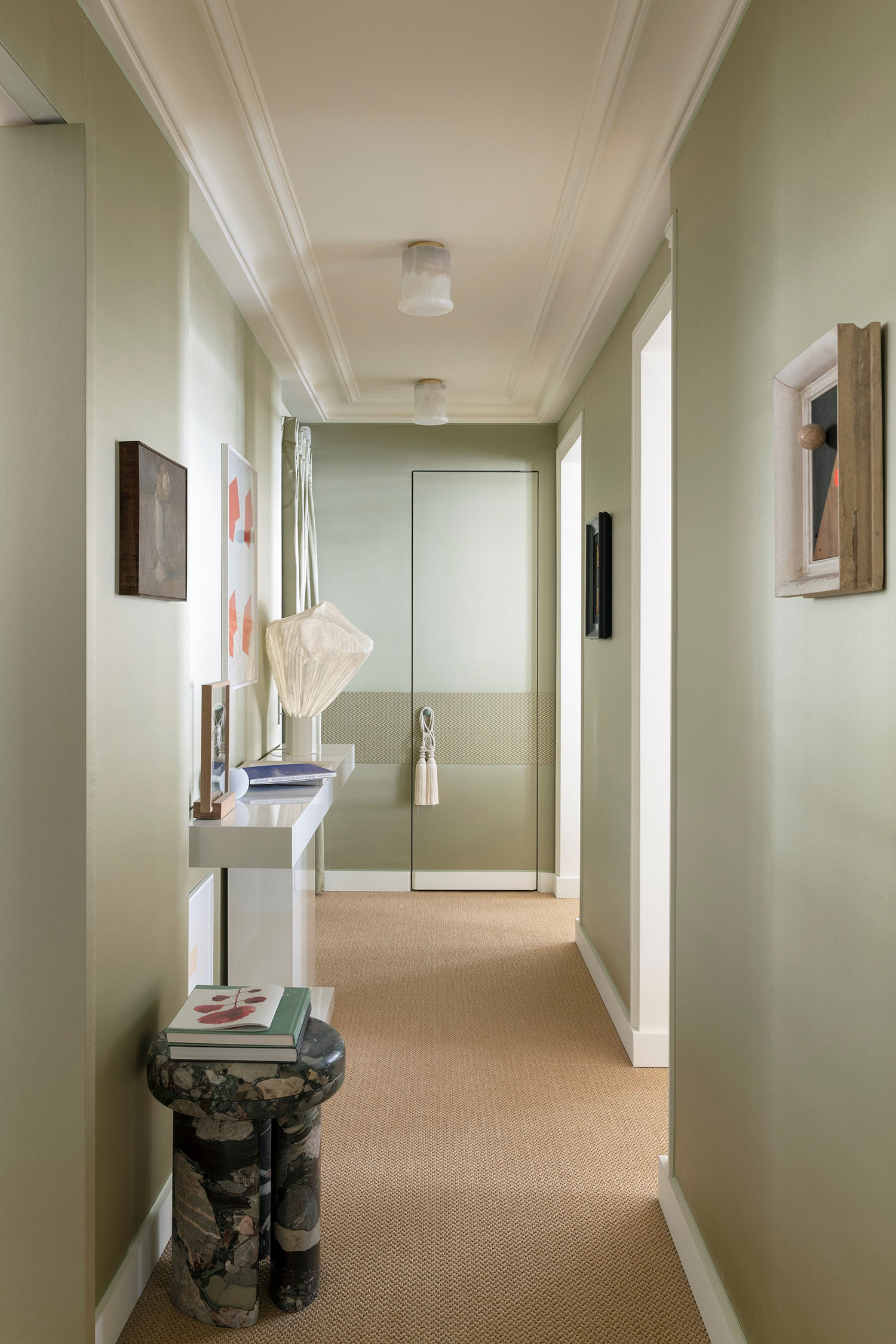 Images showcasing the stunning architectural renovation of a Haussmann apartment in Auteuil, Paris, by After Bach studio. The design blends classic Parisian charm with modern sensibilities, highlighting the use of natural materials, a sophisticated color palette, and curated artwork.