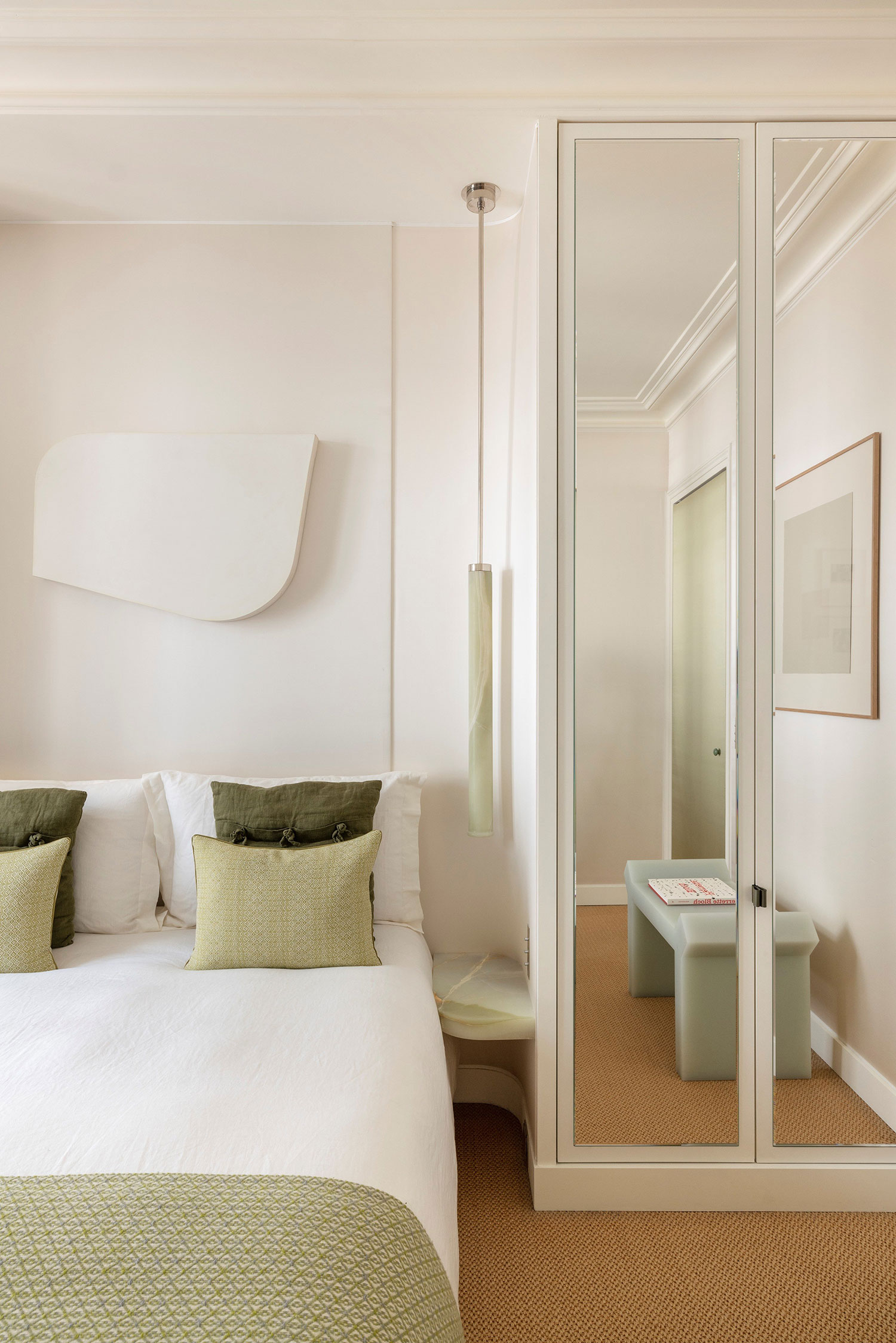 Images showcasing the stunning architectural renovation of a Haussmann apartment in Auteuil, Paris, by After Bach studio. The design blends classic Parisian charm with modern sensibilities, highlighting the use of natural materials, a sophisticated color palette, and curated artwork.