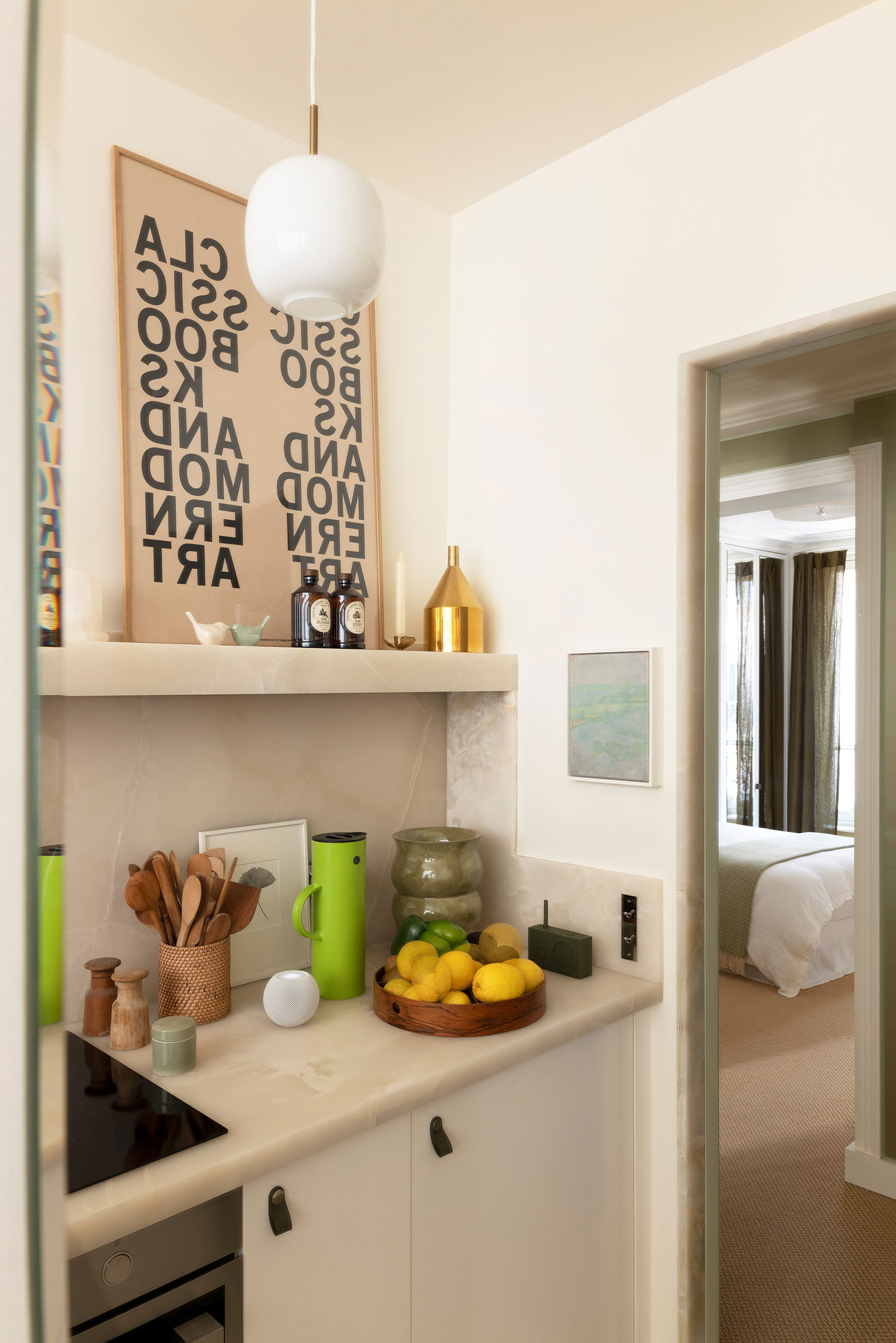 Images showcasing the stunning architectural renovation of a Haussmann apartment in Auteuil, Paris, by After Bach studio. The design blends classic Parisian charm with modern sensibilities, highlighting the use of natural materials, a sophisticated color palette, and curated artwork.