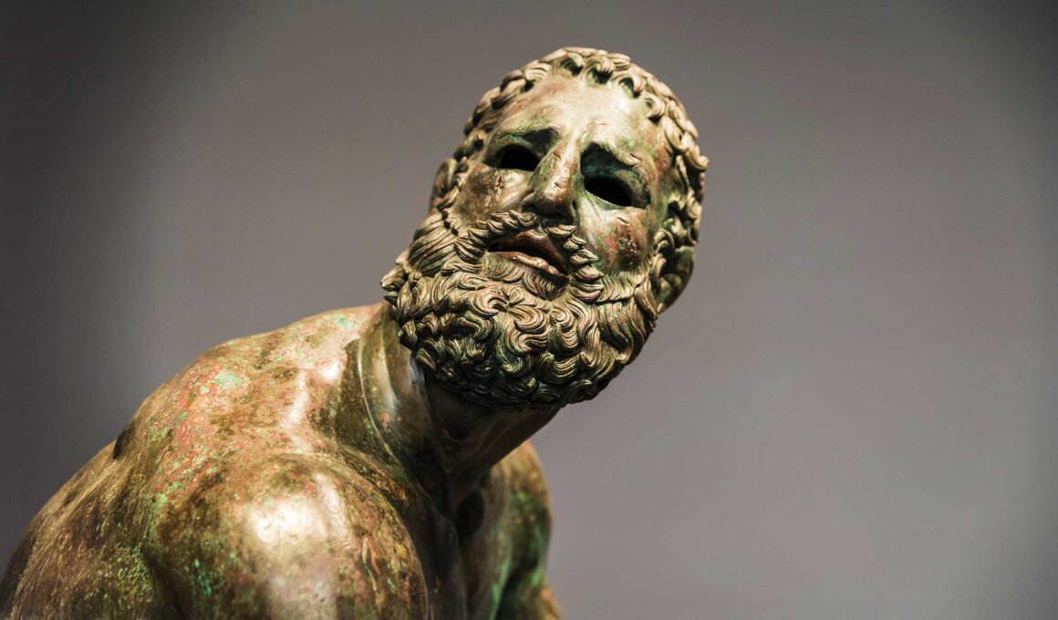 Roman bust or statue made with bronze of a human face called The fighter of the thermal bath or pugil at rest in Rome, Italy