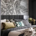 Eclectic bedroom with distressed wood furniture, layered textiles, and asymmetrical decor showcasing the shambolism design trend.