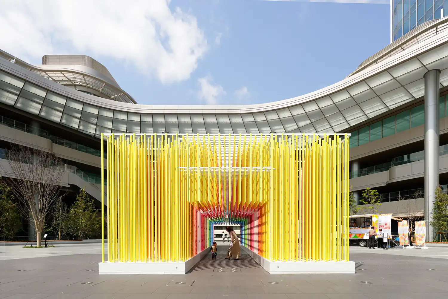 Vertical strands in 100 gradient colors forming Emmanuelle Moureaux's "100 colors path" immersive art installation at Takanawa Gateway City, Tokyo