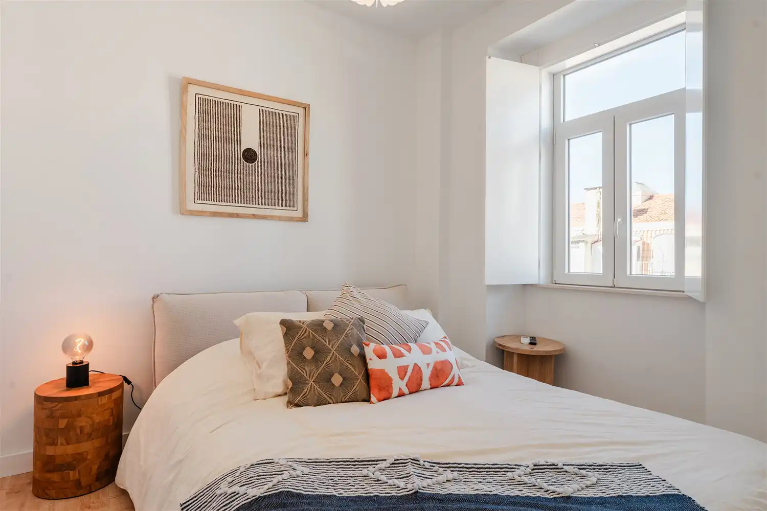 Elegant bedroom in Stay Intendente, Lisbon, featuring a plush queen-size bed, soft lighting, and stylish decor