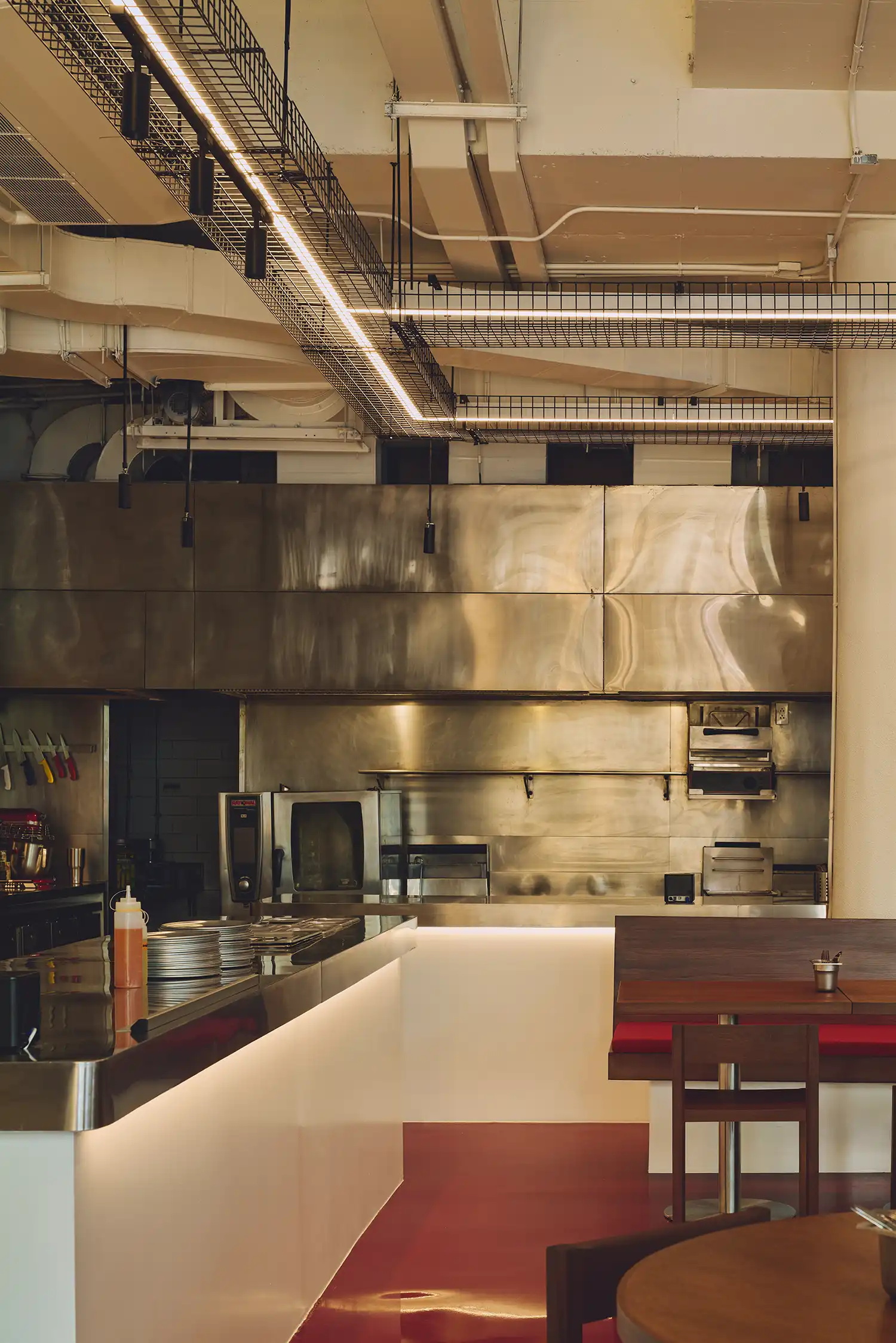 Sliding glass panels fully opened at PI SHOP Bangkok restaurant, blending indoor dining with 72 Courtyard.