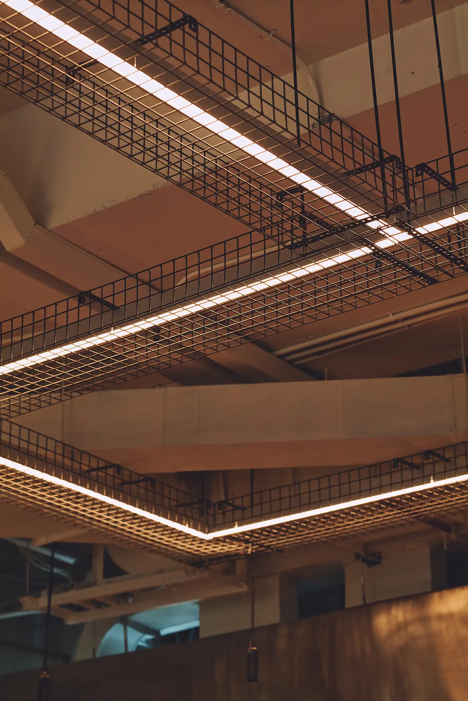 Takian wood chairs and industrial cable tray light fixtures in Affin Design's PI SHOP interior, Bangkok.