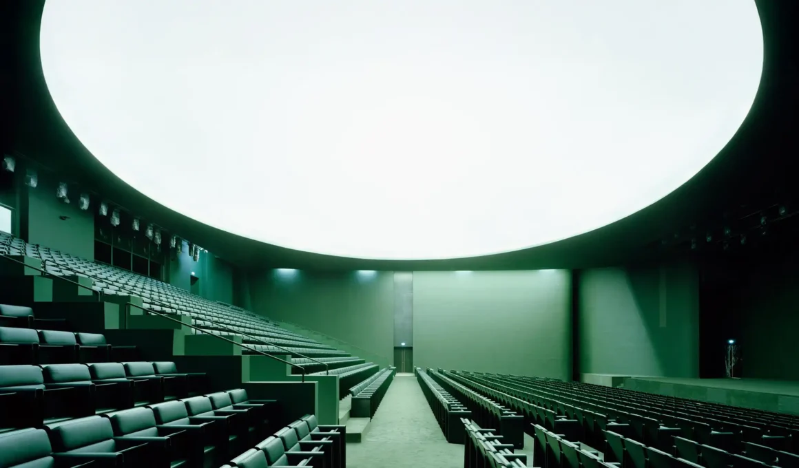 Bofill Taller de Arquitectura's Centre de Congrès Rabat: grand arched facade with bright tile cladding at UM6P University