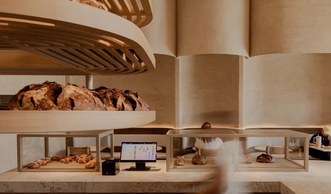 Rammed earth bar & reclaimed wood seating at Mallol's sustainable Krume Bäcker bakery in Panama City, Panama