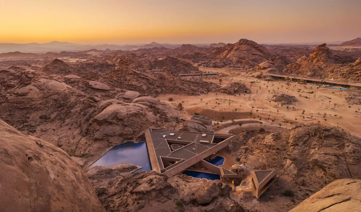 Aerial view of Desert Rock Resort in Saudi Arabia's Hejaz mountains - camouflaged sustainable architecture by Oppenheim blending into tectonic landscape