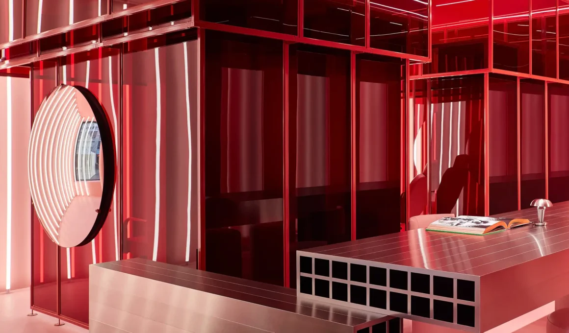 POUTx Toronto futuristic injectables clinic interior: vibrant pink micro-cement walls, stainless steel welcome desk, neon lighting, open-plan pods by Studio Author