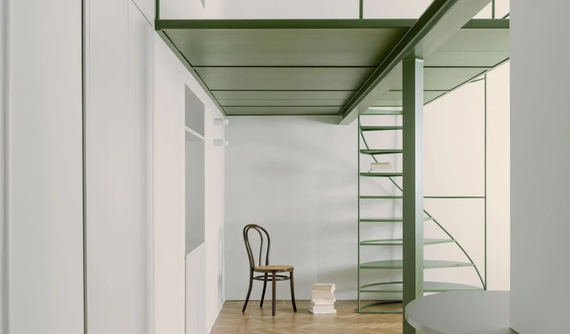 SOLUM Studio's 4cm lightweight mezzanine cantilevering over Milan historic apartment, featuring semicircular iron staircase & rotated steel pillar.