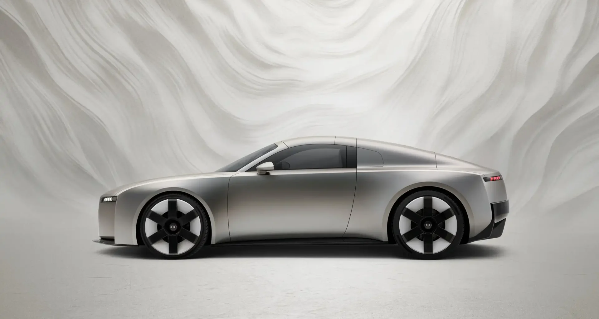 Audi Concept C all-electric roadster in titanium finish, showcasing new vertical frame grille and radical simplicity design philosophy on a dynamic turntable.