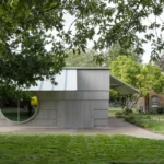 Carmody Groarke's low-carbon timber ArtPlay Pavilion at Dulwich Picture Gallery, London, with large circular windows and overhanging canopies.