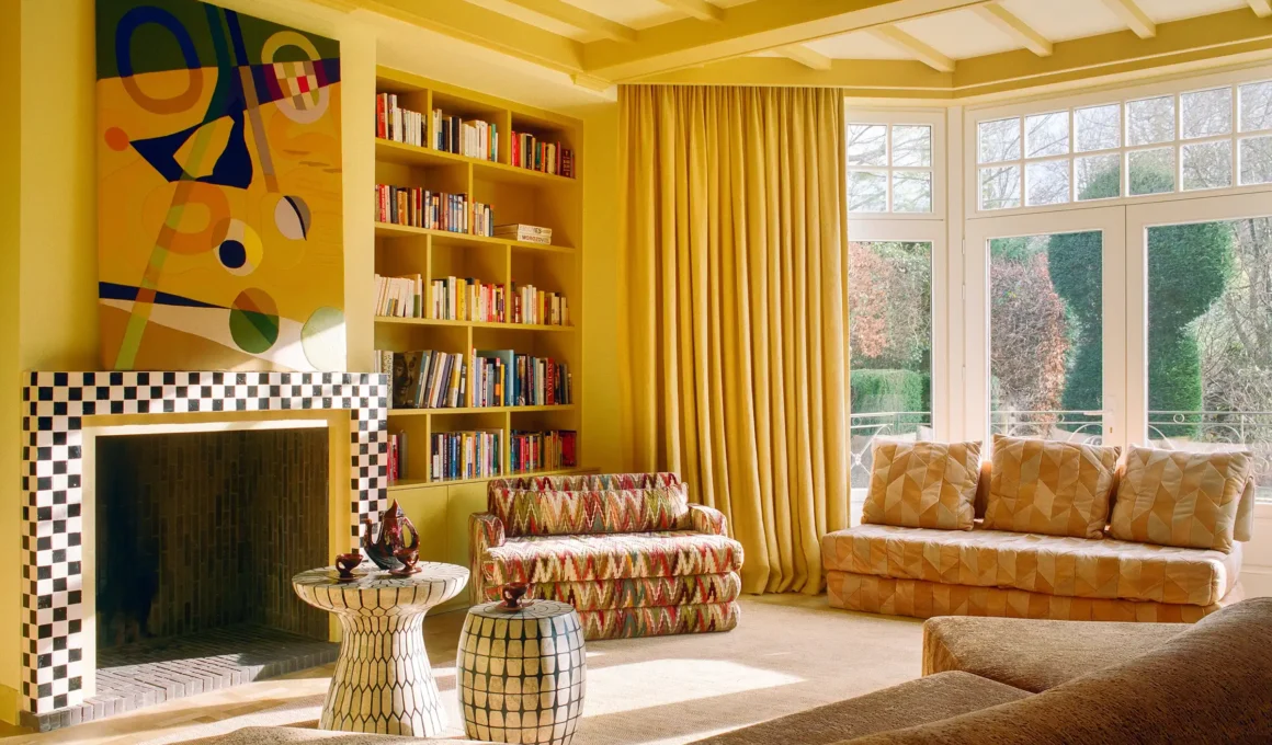 Dimitri townhouse Brussels living room interior design by Victoria-Maria featuring eclectic furniture, vibrant art, and abundant natural light in a renovated townhouse.