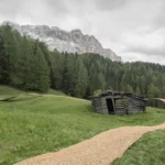 ELSE Trace of Land hay bale art installation meandering through alpine meadow at SMACH 2025 in the Italian Dolomites, Val Badia.