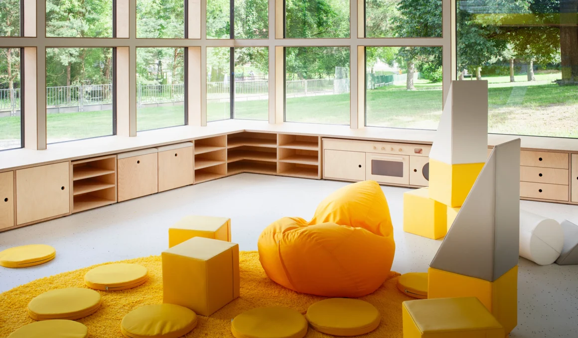 Fulnek Kindergarten by XTOPIX architekti charred pine facade blending into forest slope with square windows and outdoor courtyard